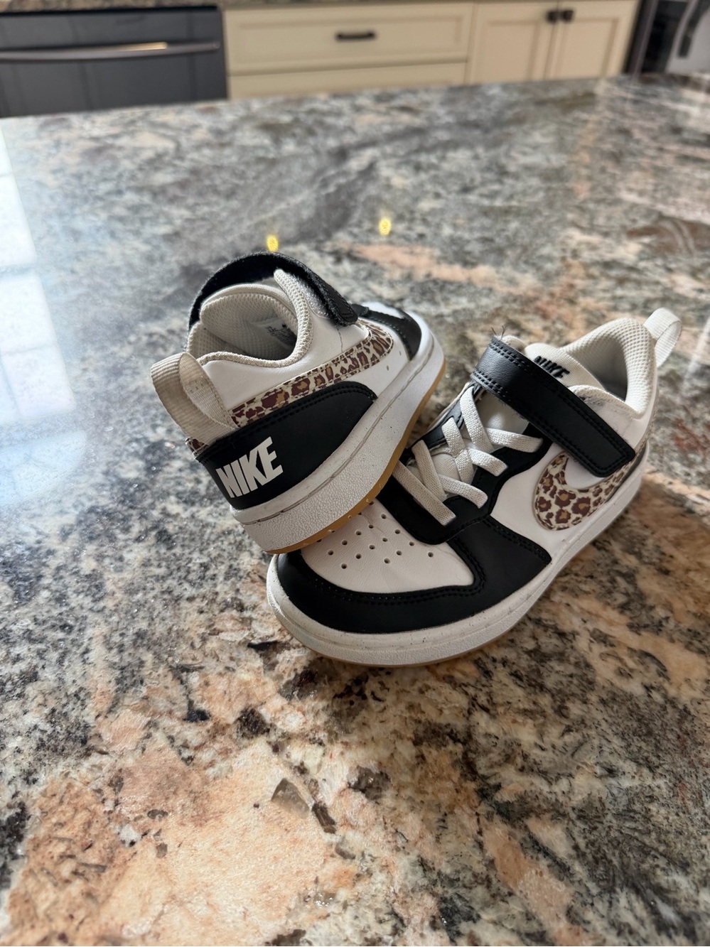 Nike Kids Black and White Sneakers with Leopard Swoosh Accent